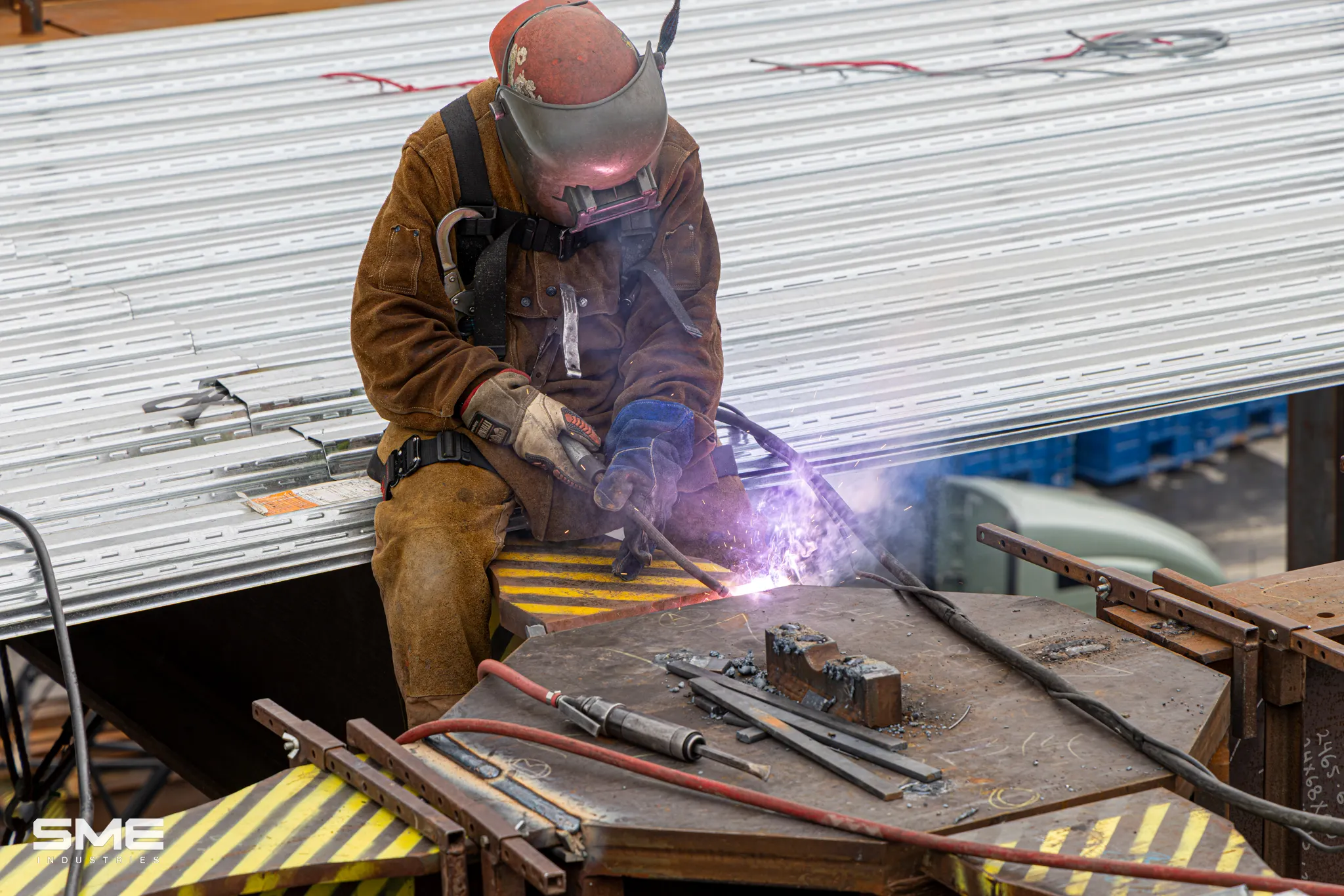 man welding a steel column